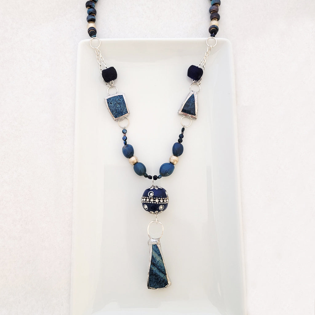 Handmade, one of a kind necklace of blue pottery, varied blue agate stones, glass and ceramic beads.