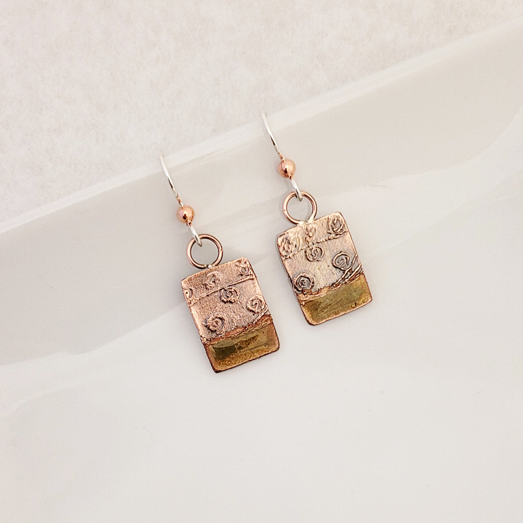 Handmade earrings. Hand-fabricated copper rectangle, etched with swirl design, bottom with lime green enamel work