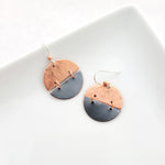 Handmade earrings of copper split circles with patina charcoal on bottom, connected with copper hoops