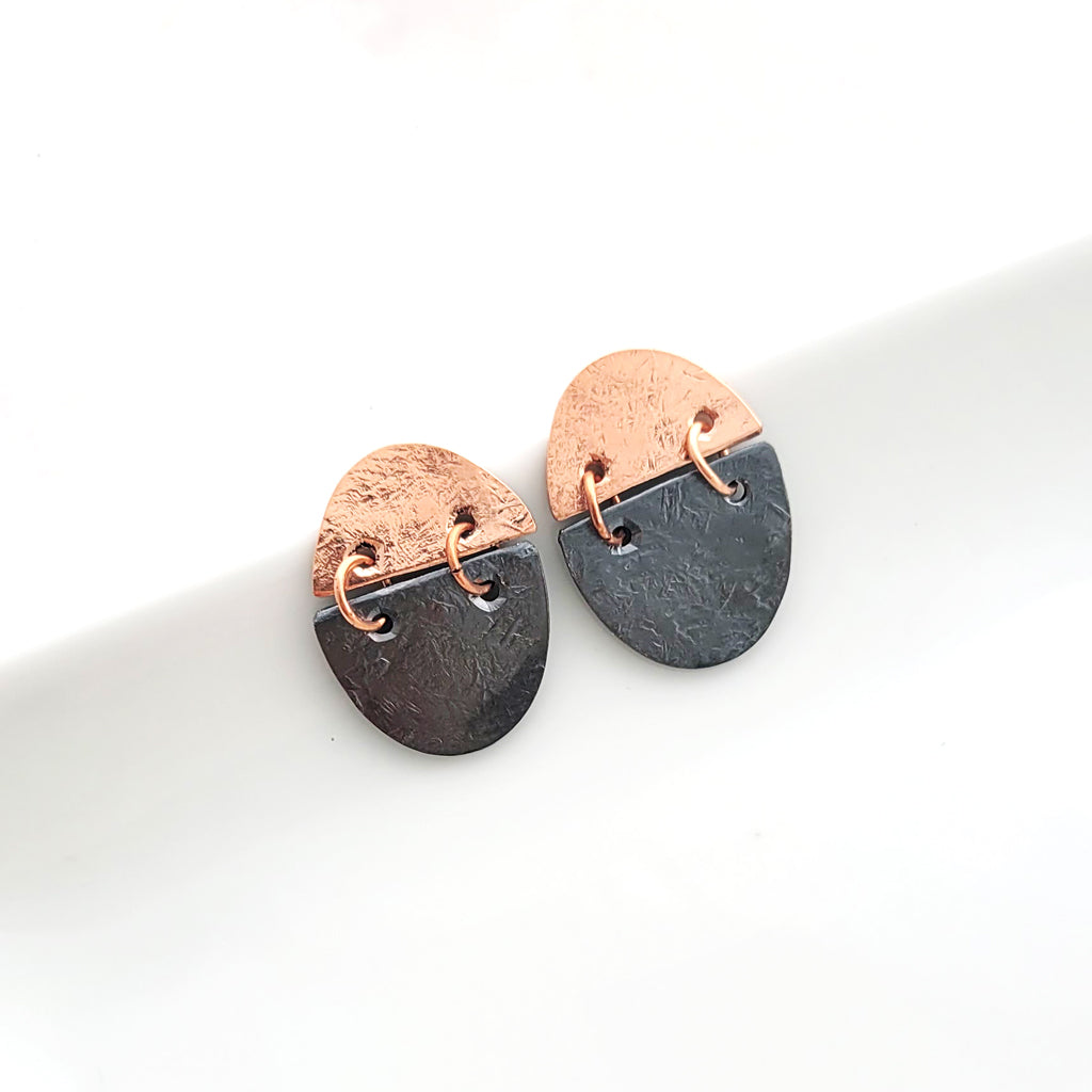 Handmade earrings in copper and patina charcoal oval split and connected with copper hoops.