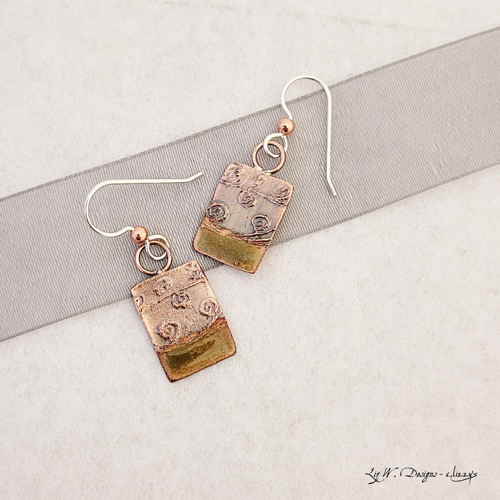 Handmade earrings. Hand-fabricated copper rectangle, etched with swirl design, bottom with lime green enamel work