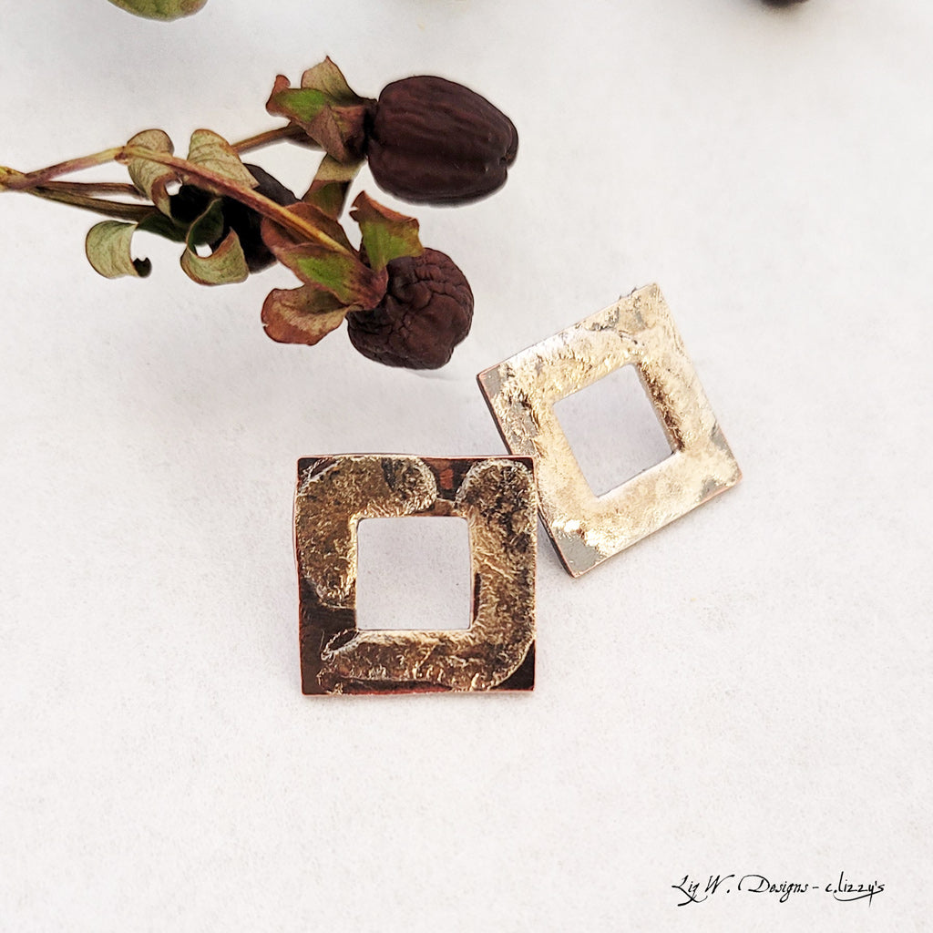 Handmade earrings, textured open copper squares with abstract sterling silver overlay that has hints of gold-tones