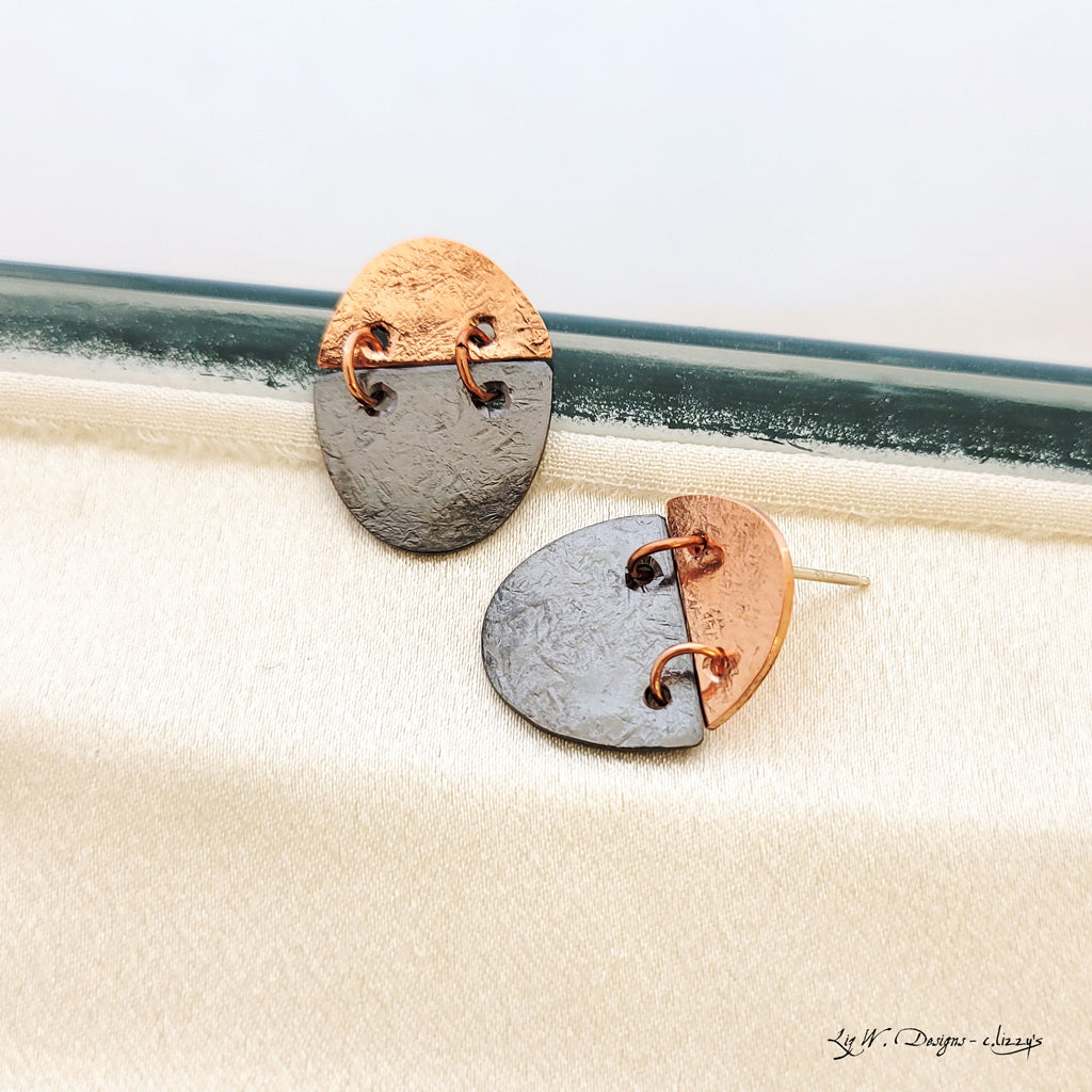 Handmade earrings in copper and patina charcoal oval split and connected with copper hoops.