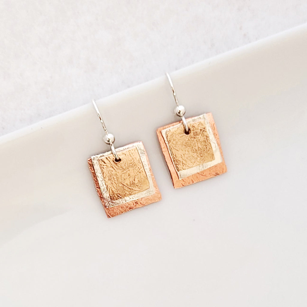 Handmade Earrings - Textured bronze, sterling silver and copper squares in layered stack.