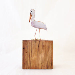Hand-fabricated copper pelican enameled in white and dark orange on found wood.