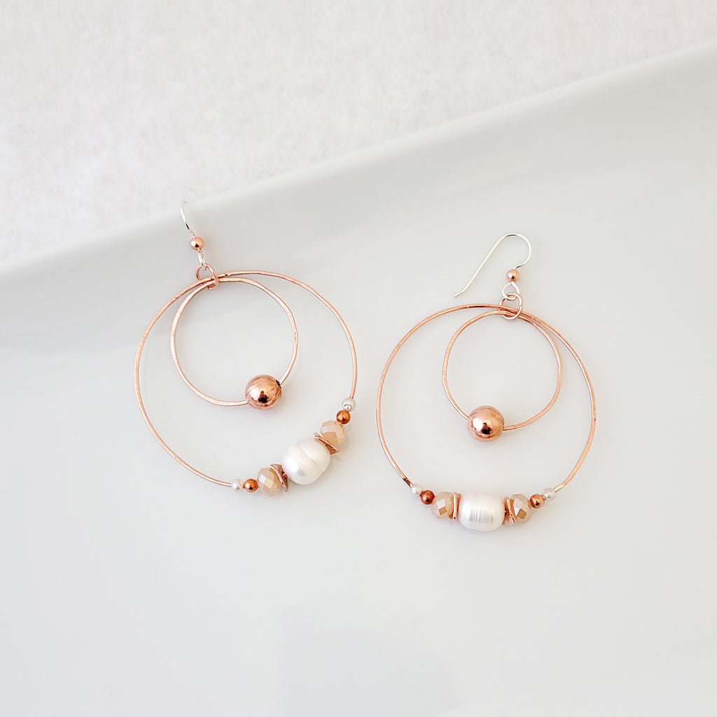 Handmade earrings large copper circles that are lightweight, featuring copper beads, cultured pearl and crystals