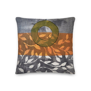 Pillow of original art. Avocado green circle on gray and light burnt orange background with off-white leaf design.