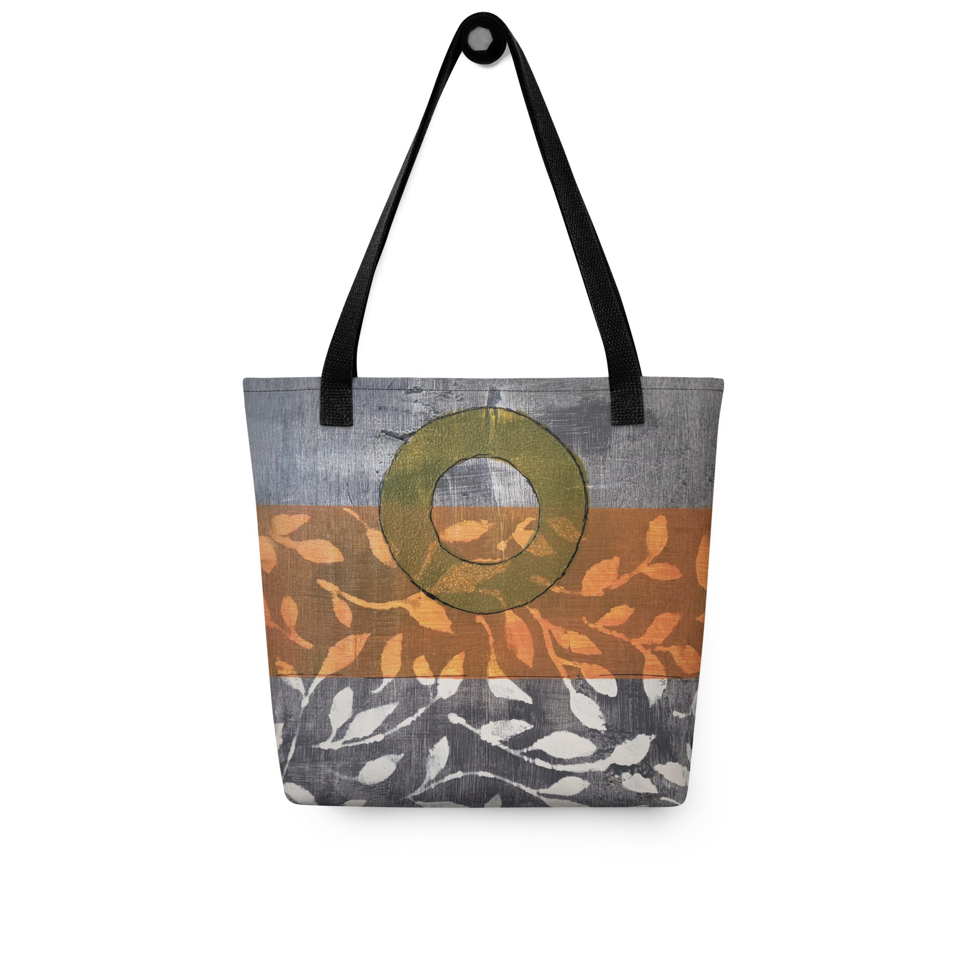 Tote bag of original art.  Avocado green circle on gray and light burnt orange background with off-white leaf design.