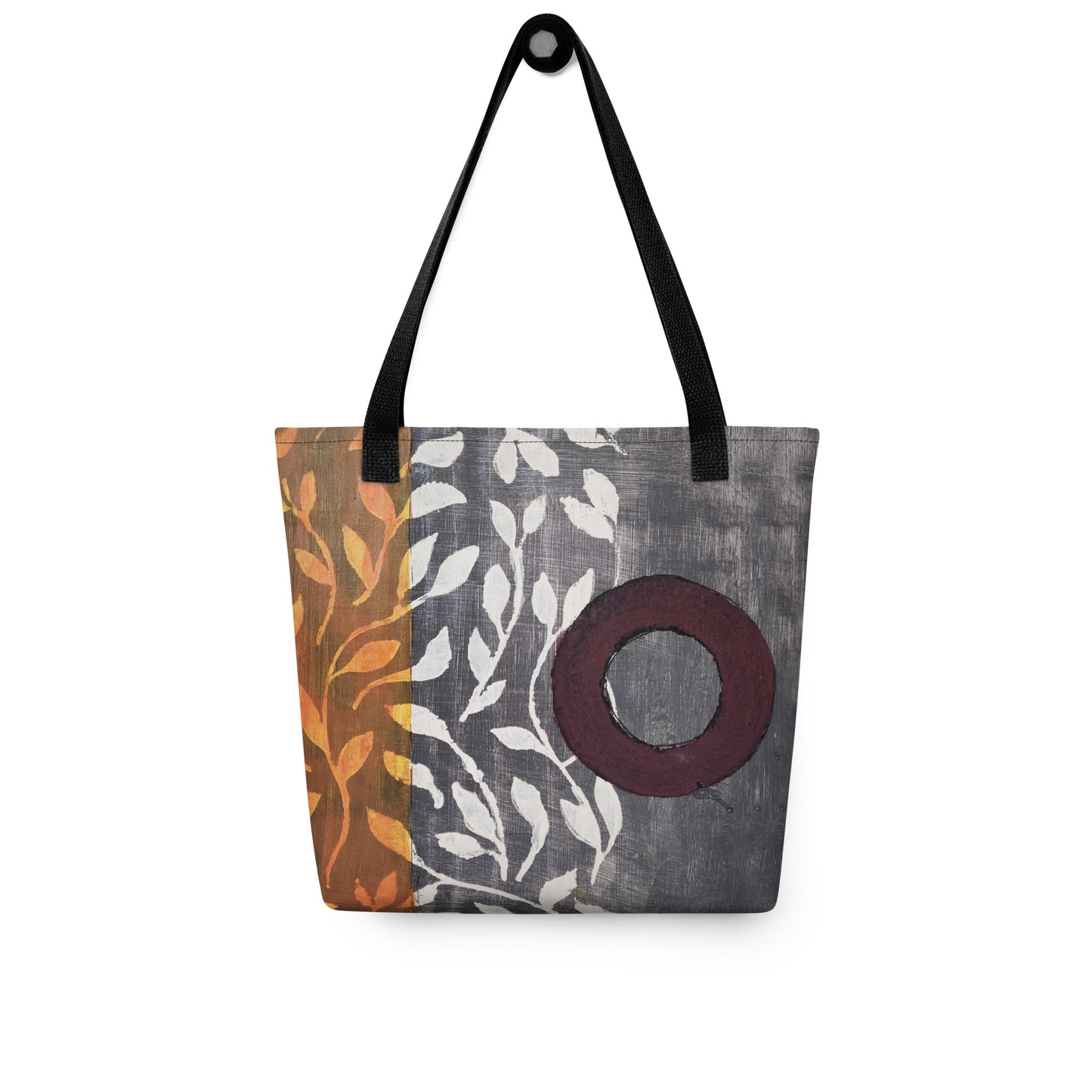 Tote bag of original art. Plum circle on gray and light burnt orange background with off-white leaf design.